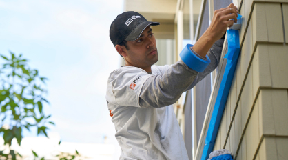 Pro painter taping off an exterior wall